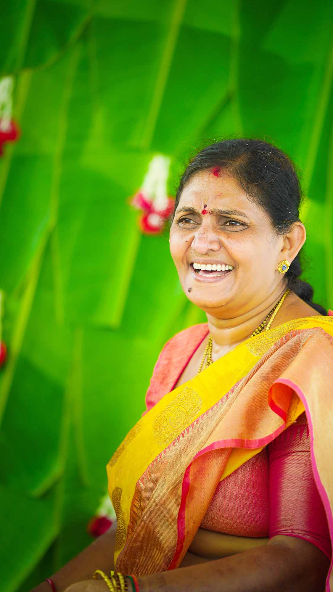 family-candids-a-candid-portrait-of-the-brides-mother-at-the-haldi-ceremony