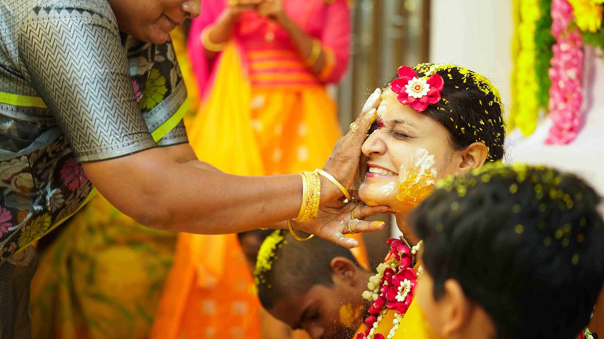 haldi-ritual-a-brides-aunt-applies-turmeric-paste-at-a-haldi-ceremony